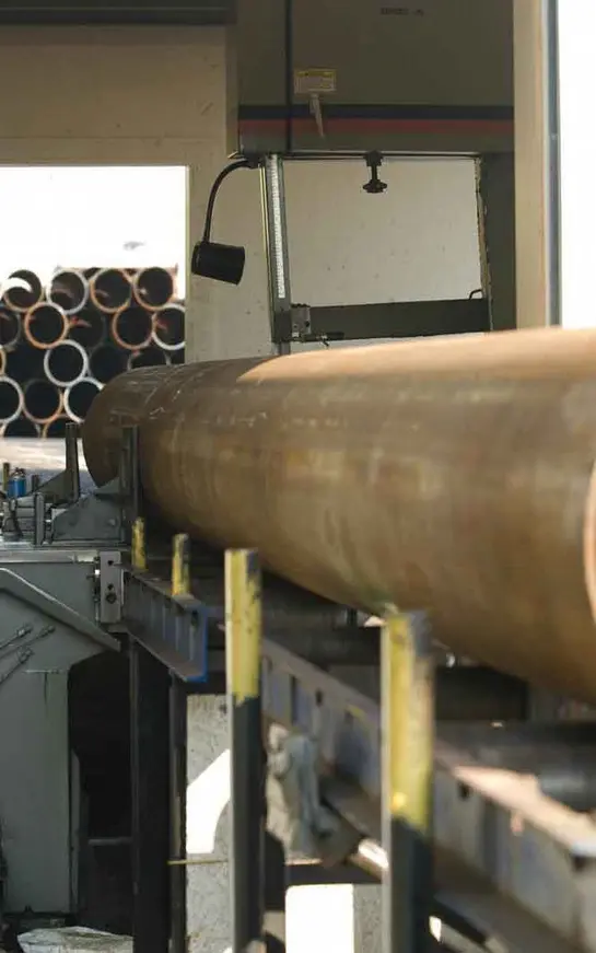 A large pipe is being worked on the machine.