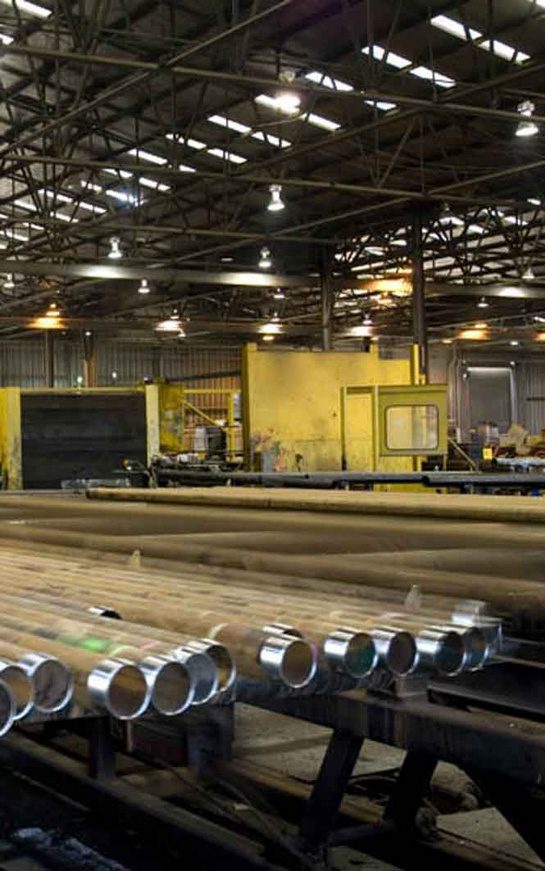 A large warehouse with many pipes and machines.