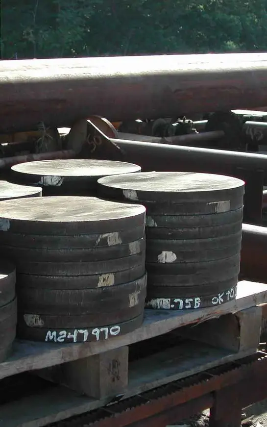 A bunch of black cylinders sitting on top of some metal.