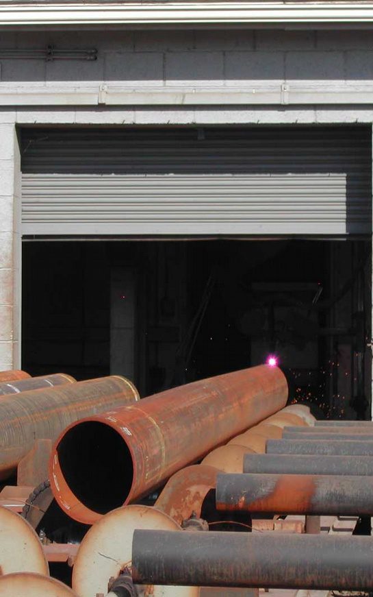 A large pipe sitting in front of a building.