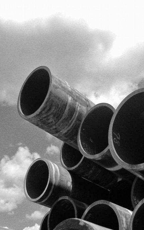 A black and white photo of some pipes in the sky.
