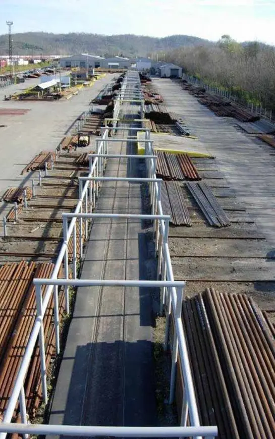 A long walkway with many wooden planks on it