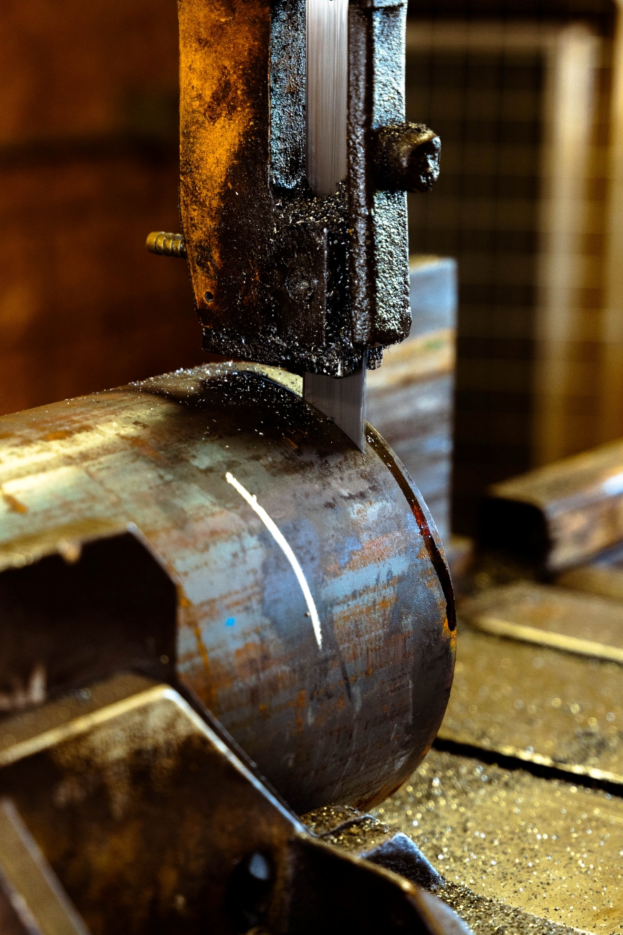 Close up of a machine's blade cutting a metal pipe